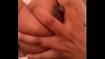 Ebony babe playing with her tits and soaking pussy while bathing