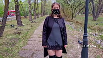 Hot girl in a very short dress walks in the park and flashes her pussy