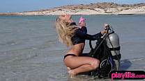 Perfect blondie model at the sea practicing her diving skills