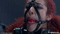 Shackled and lied on her back in latex suit ebony slave Daisy Ducati gets feet tormented then spanked and whipped and anal fingered by master The Pope