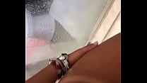 Young girl teasing bikini tan in shower