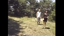 Cute girl and a hot guy are getting threesome fuck outdoor