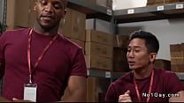 Asian worker Jkab Ethan Dale gets throat fucked by his black colleague Andre Donovan then anal fucked with his big black cock in stockroom