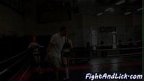 Muscular women wrestling in a boxing ring