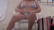 Stepmother shows off in a bikini on the beach and gets on all fours to fuck