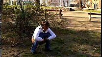 Girl pissing in a public park