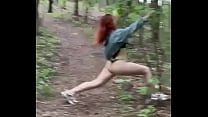 Sexy redheaded pussy walks through the woods almost naked