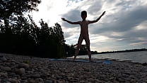 Skinny naturist twink practices naked yoga on a nudist beach