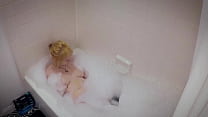 Thick blonde takes a bubble bath,shower, and rubs her cunt