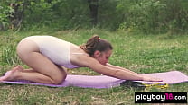 Petite naked beauty doing her daily yoga workout outdoor