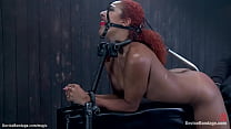 Gagged redhead ebony Daisy Ducati in latex bound on illuminating table gets pussy vibrated then zippered till shackled ass hooked and tied to hair