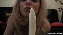 Poking the shaved pussy with a white dildo
