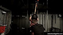 Bondage girl lifted upside down in helpless damsel in distress session