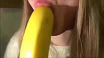 young blonde licking banana