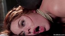 Redhead sub Amarna Miller in standing bondage with arms tied up behind back gets nipples clamped and pulled by rope then in backbend position whipped