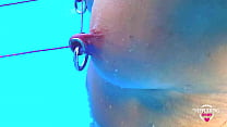 nippleringlover kinky mother extreme stretched nipple piercings tied together with tight rope outside in swimmingpool