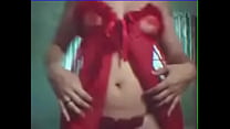 Slutty teacher Daniela in a cam show in a red dress doing a strip