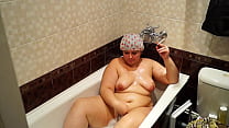 A mature BBW lay down in the bath, lit a cigarette and smokes relish.