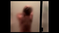 Sexy big tits redhead gets naked and dances and shakes her melons in the shower.