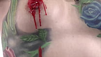 Busty tattooed fetish model drips hot candle wax all over her body