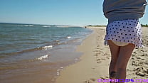 Diapered girl relaxes on the beach